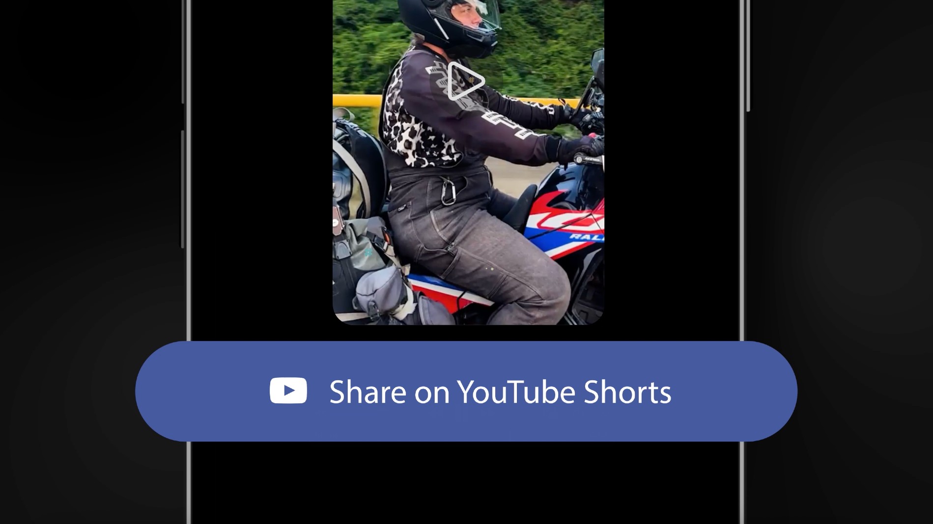 A motorcycle rider in a black and white patterned jacket and helmet is visible in a vertically framed video, with a prominent button at the bottom that reads 