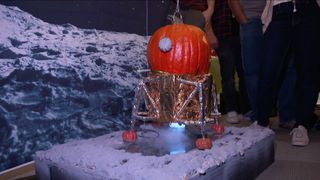 An Apollo 11 pumpkin lander approaches the moon in this entry in the 2019 pumpkin carving contest at NASA's Jet Propulsion Laboratory in Pasadena, California. It was one of many space-themed pumpkins this year.