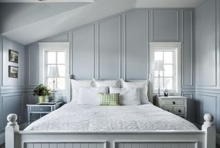 Grey panelled bedroom with white linen