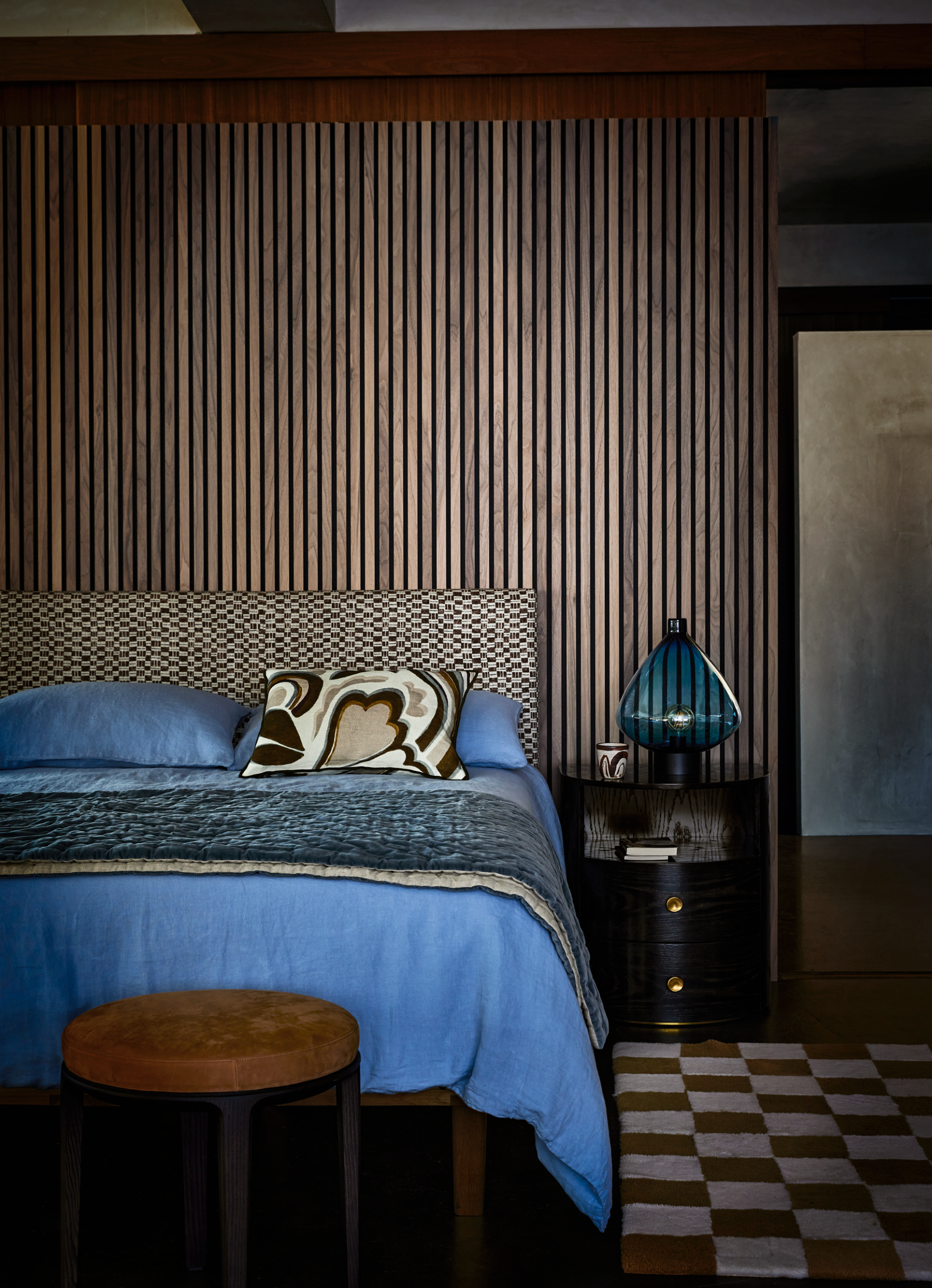 a atmospheric bedroom with neutral scheme and bright blue sheets