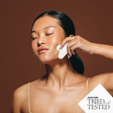 Lymphatic drainage: A woman using a gua sha on her face