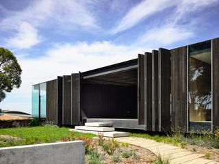 Open entrance of villa with stainless steel planks either side