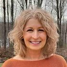 Pam Hartnett stood in front of trees