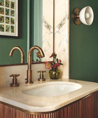 green washroom with marble topped wooden sink unit