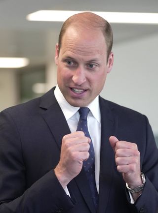Prince William in a suit, expressive with his hands
