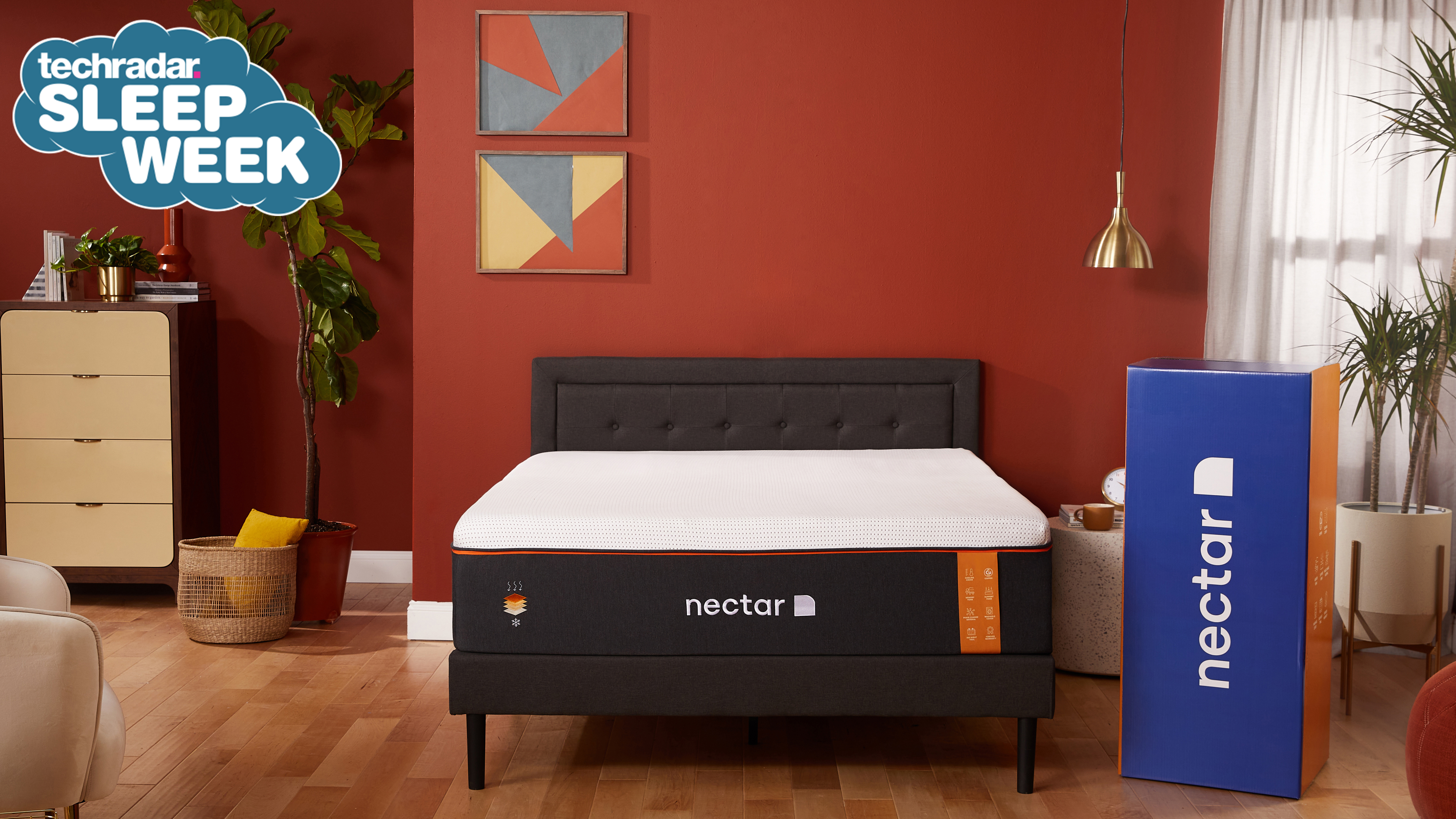 The Nectar Premier Copper Mattress on a wooden bed in a red bedroom