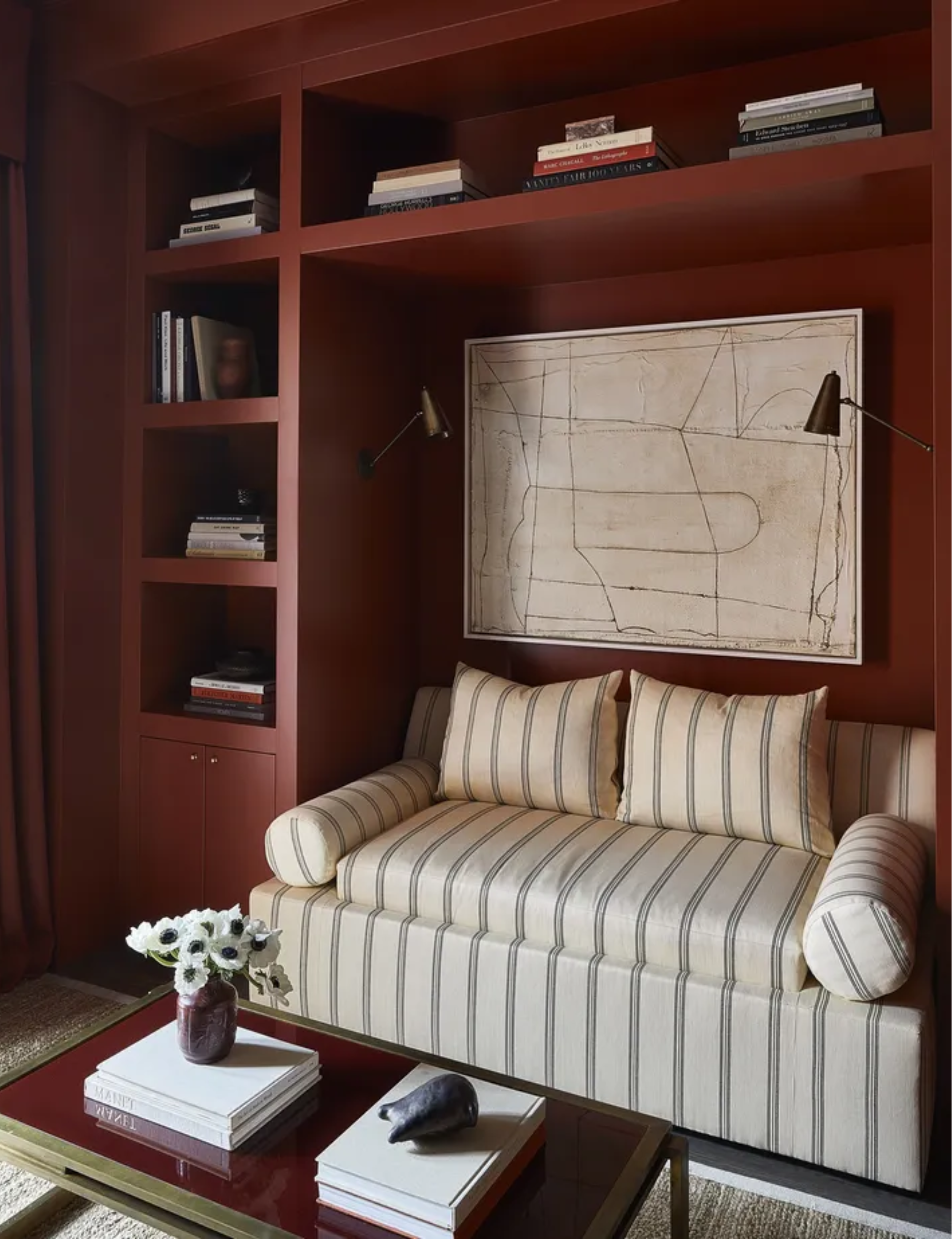 Rust living room with striped patterned sofa by Wendy Labrum