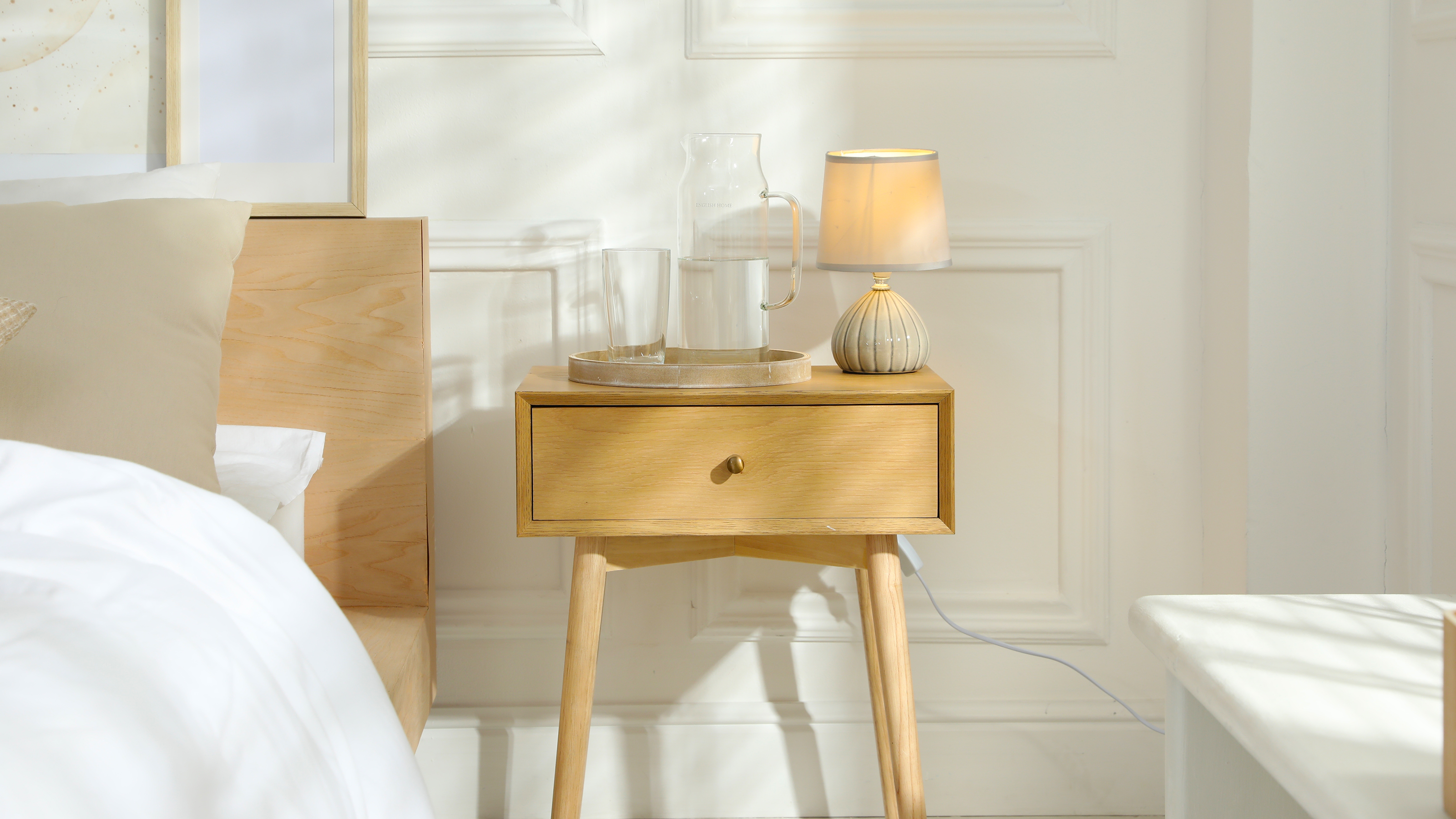 A carafe of water on a nightstand
