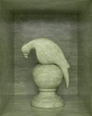 Photography of a sculpted parrot on a sphere stand