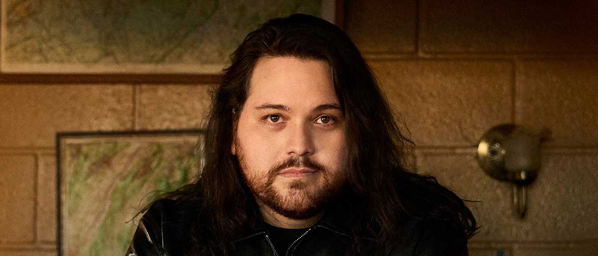 Wolfgang Van Halen seated at a desk