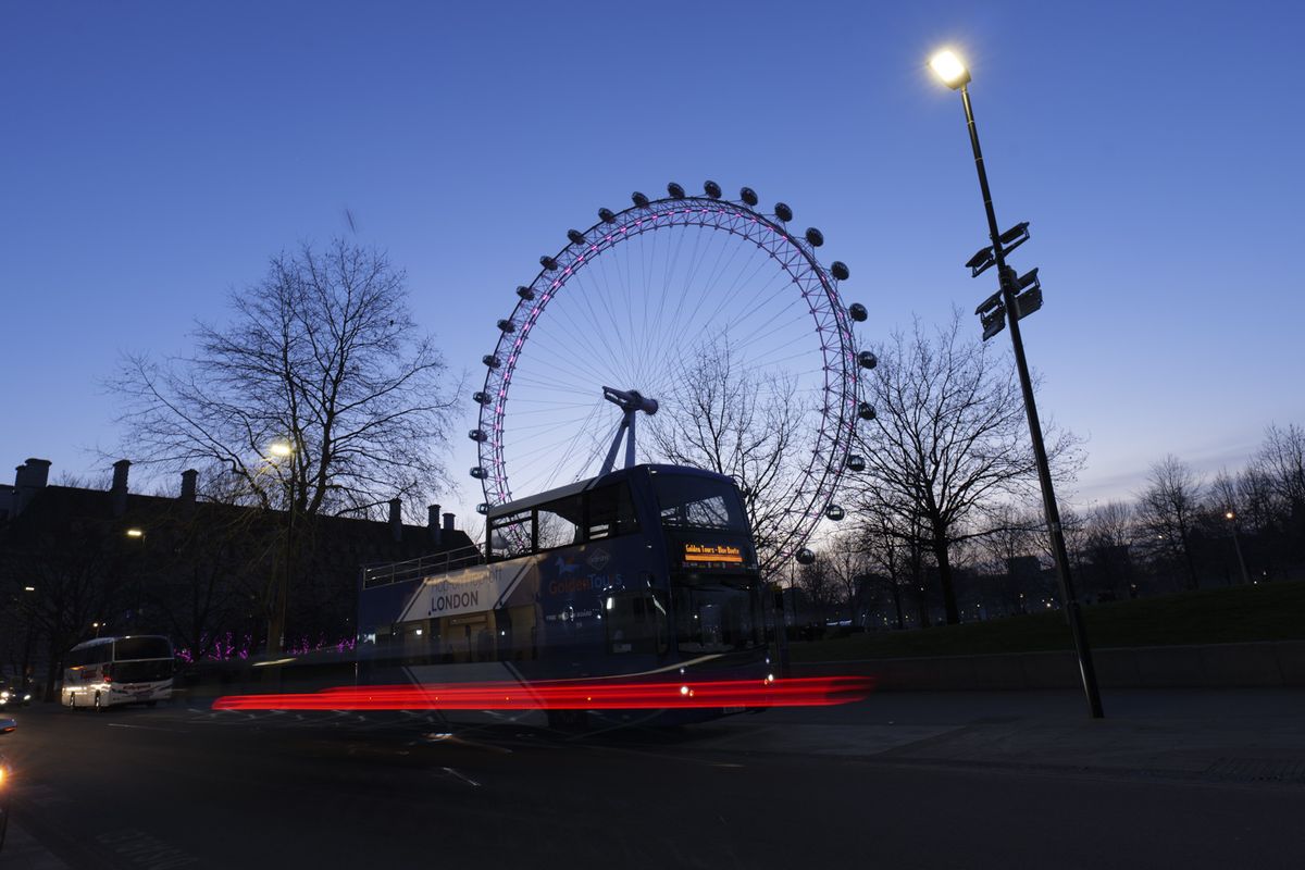 Picture taken with Panasonic S5 II of London eye toursit attraction at night with light trails in front