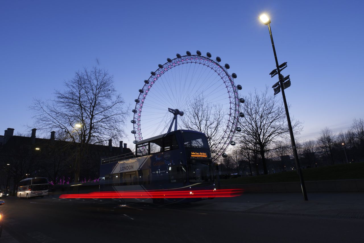 Picture taken with Panasonic S5 II of London eye toursit attraction at night with light trails in front