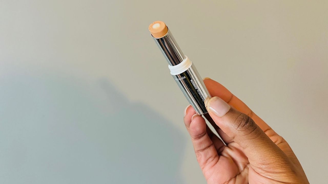 A person holding an opened Neutrogena Hydro Boost Hydrating Concealer for the best drugstore concealers.