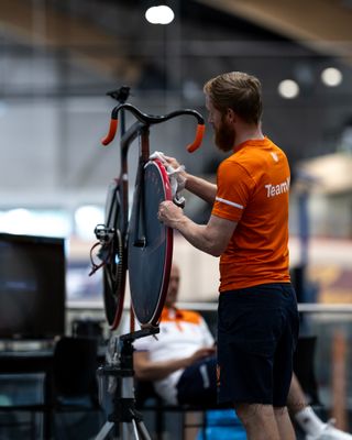 Head mechanic Tim de Boer wipes a Dugast tyre down