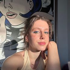 Jamie Schneider taking a selfie wearing colorful makeup