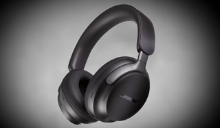 A pair of black Bose QuietComfort Ultra Headphones floating on a gray background.