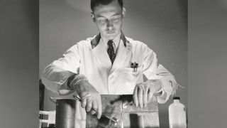 Scientist holding a vial of radioactive material 