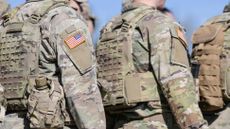 Detailed view of the US Army uniform worn by soldiers in a military base. Flag of America on the uniform.