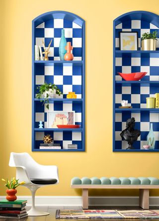 Room with yellow walls and blue and white checkered shelving