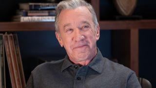 Tim Allen sits in his office smiling in Shifting Gears S1 E2, "Accommodations." 