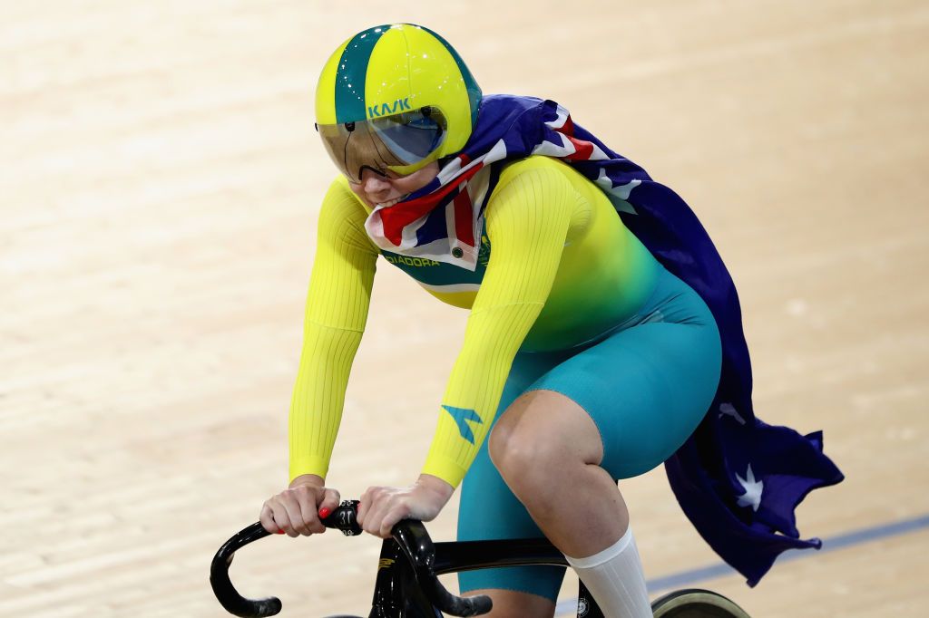 Kaarle McCulloch takes a lap with the Aussie flag