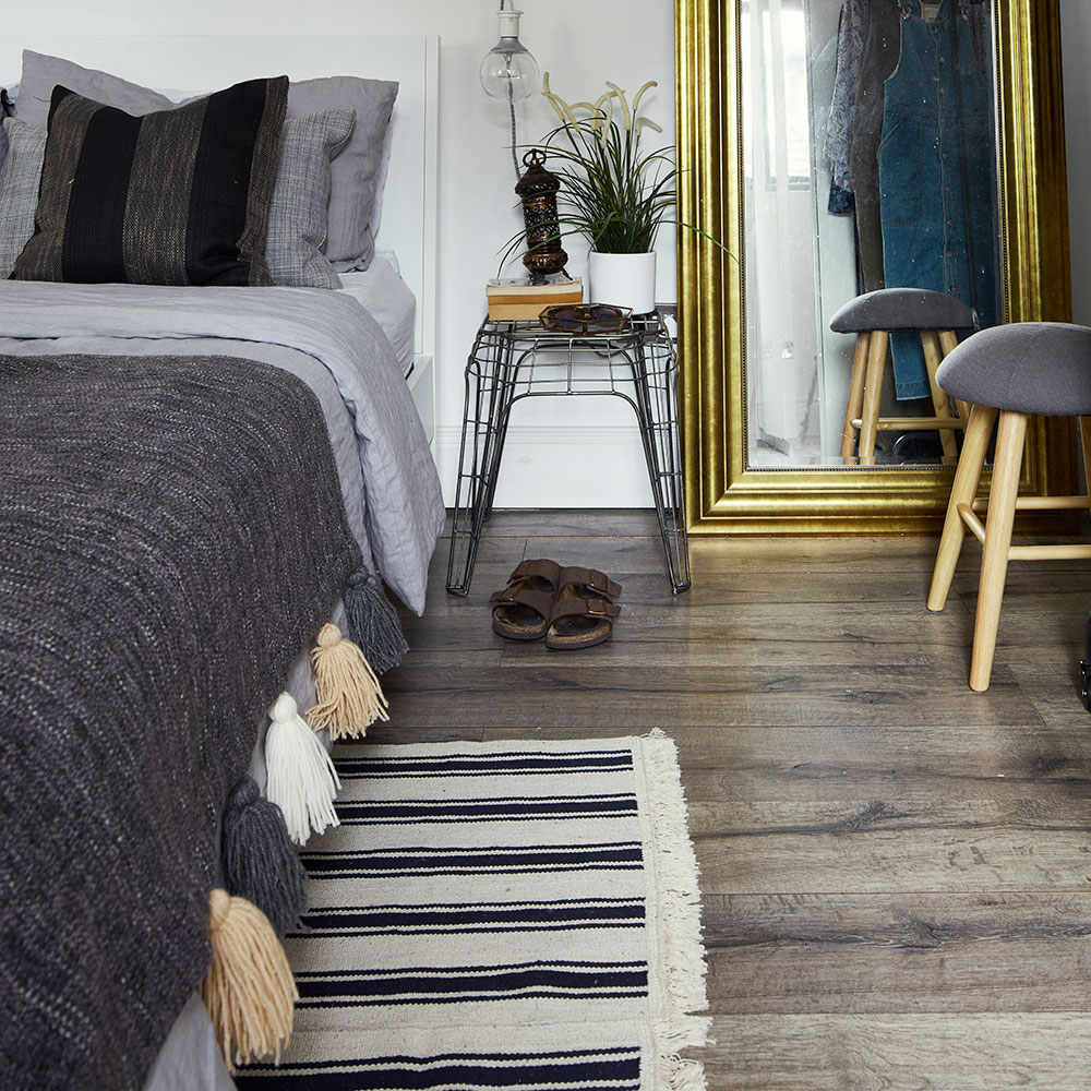 bedroom with grey bed and carpet