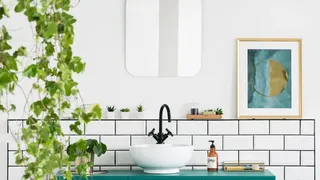 White bathroom with artwork on wall