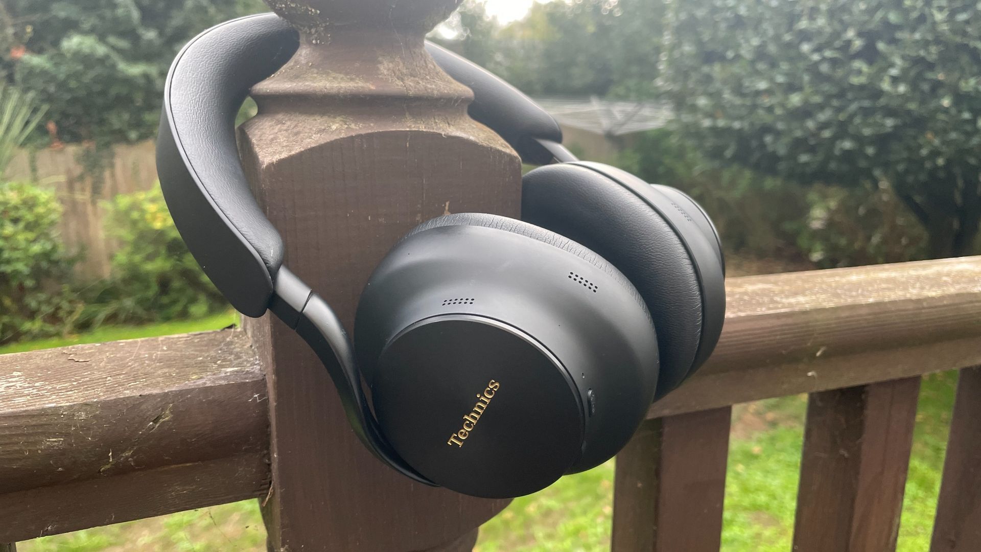 Technics EAH-A1000 headphones in black, in a garden