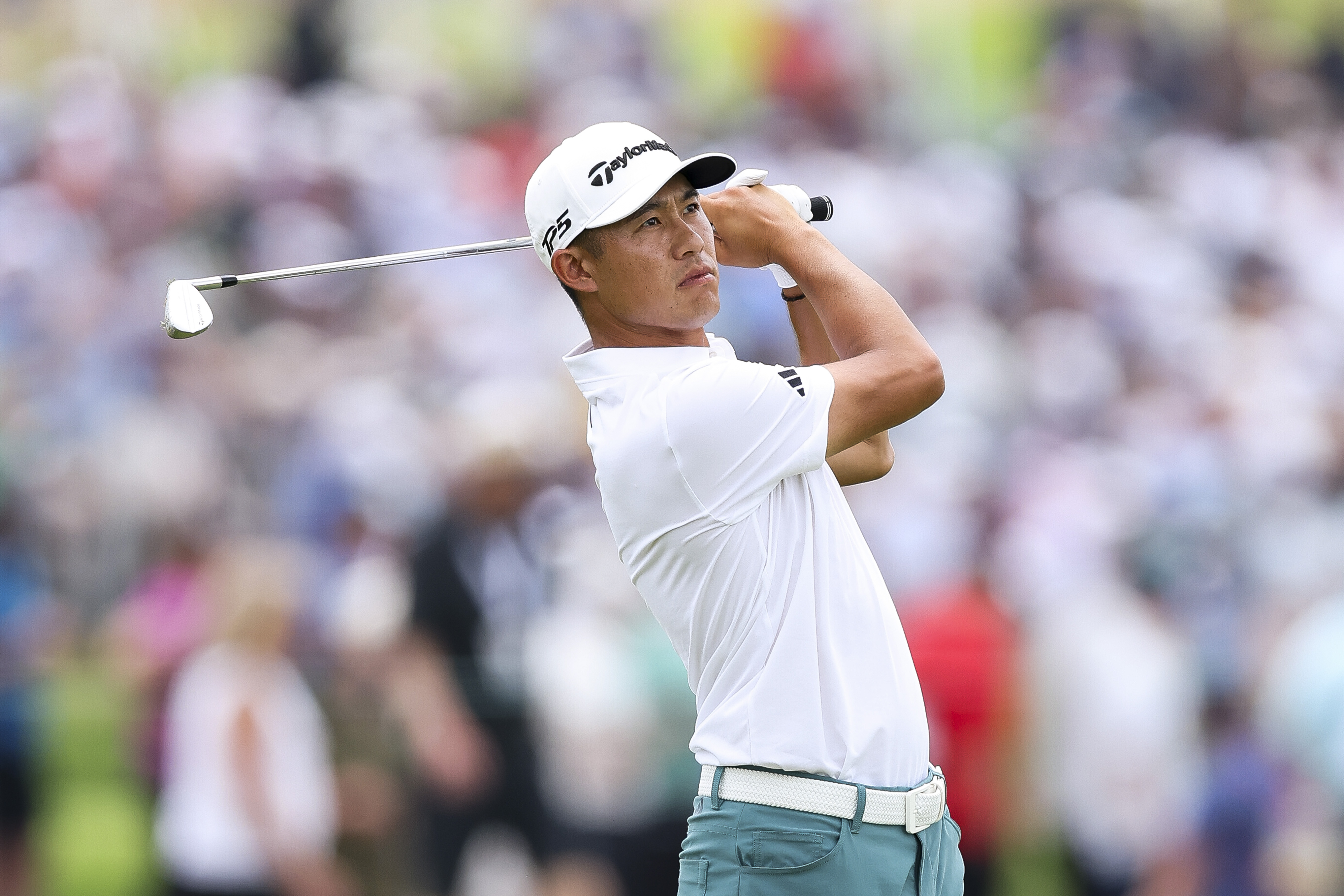 Collin Morikawa hits an iron shot