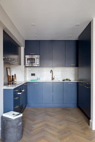 Small blue kitchen with narrow blue kitchen