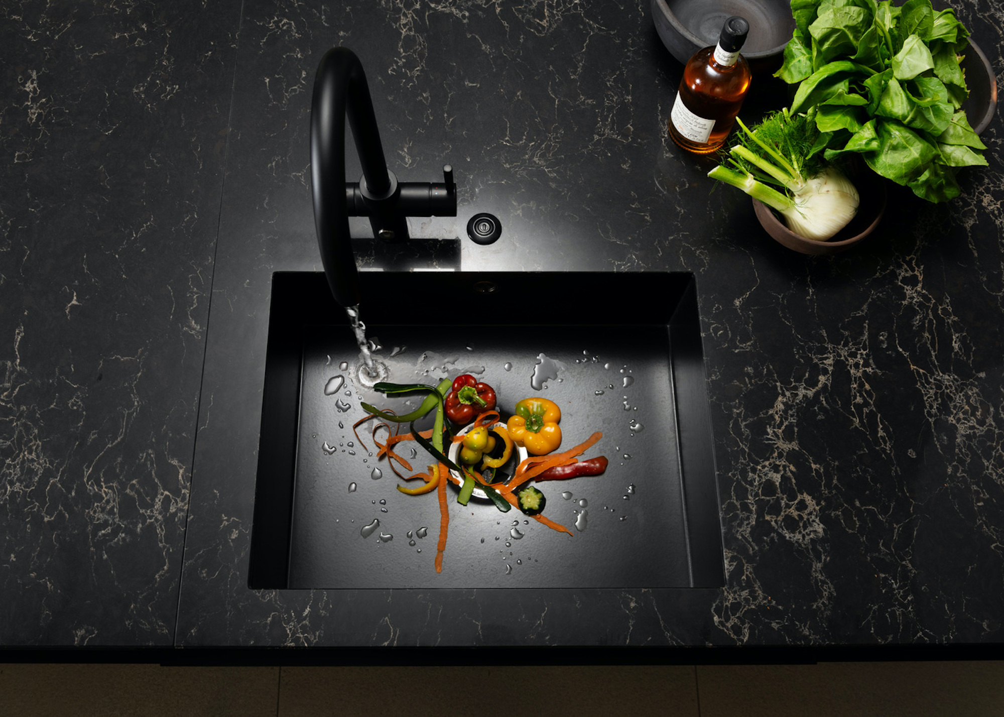 kitchen sink with food going down a maserator