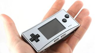 A photo of the Game Boy Micro in a hand