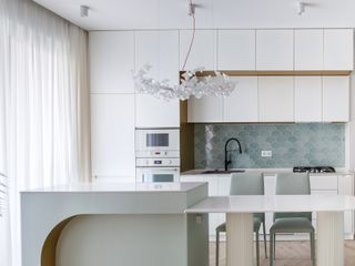 A kitchen with white linen curtains