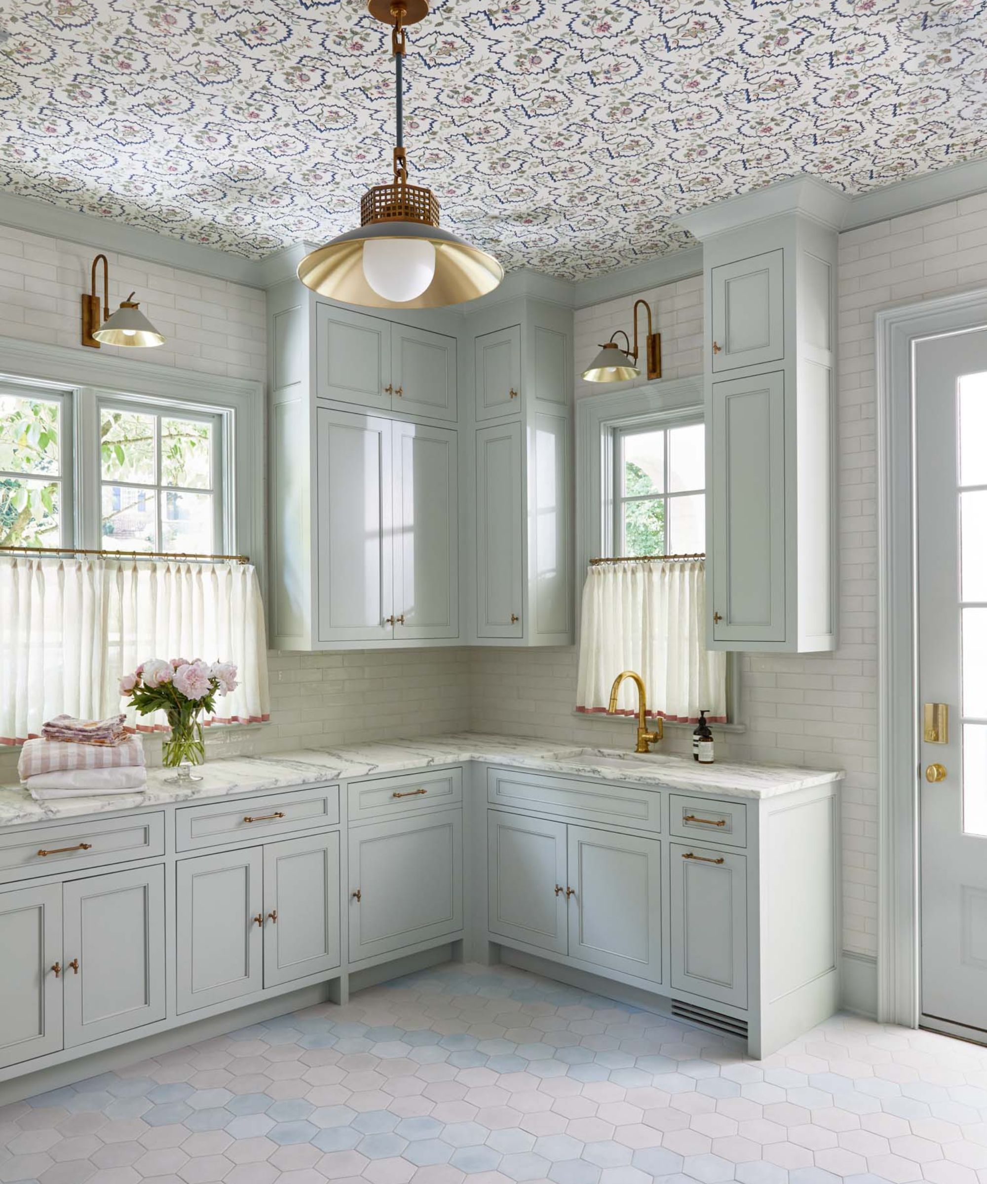 L.B Copeland laundry room with fitted cabinets and a wallpapered ceiling