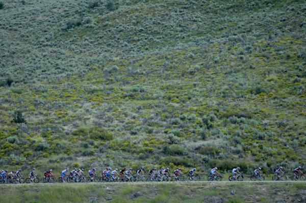 Riders almost blend into the colorful hillside heading towards the feed zone.
