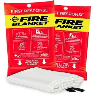 Two red fire blanket packets. A folded white fire blanket in front of them