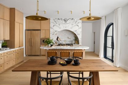 a kitchen with an island with a countertop overhang