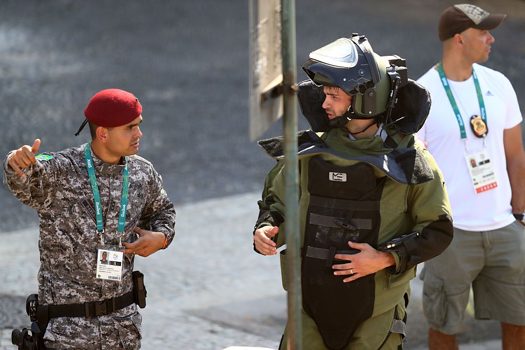 Members of the Brazillian bomb squad carry out a controlled explosion of a bag near the finish line of the Men&amp;#039;s Road Race