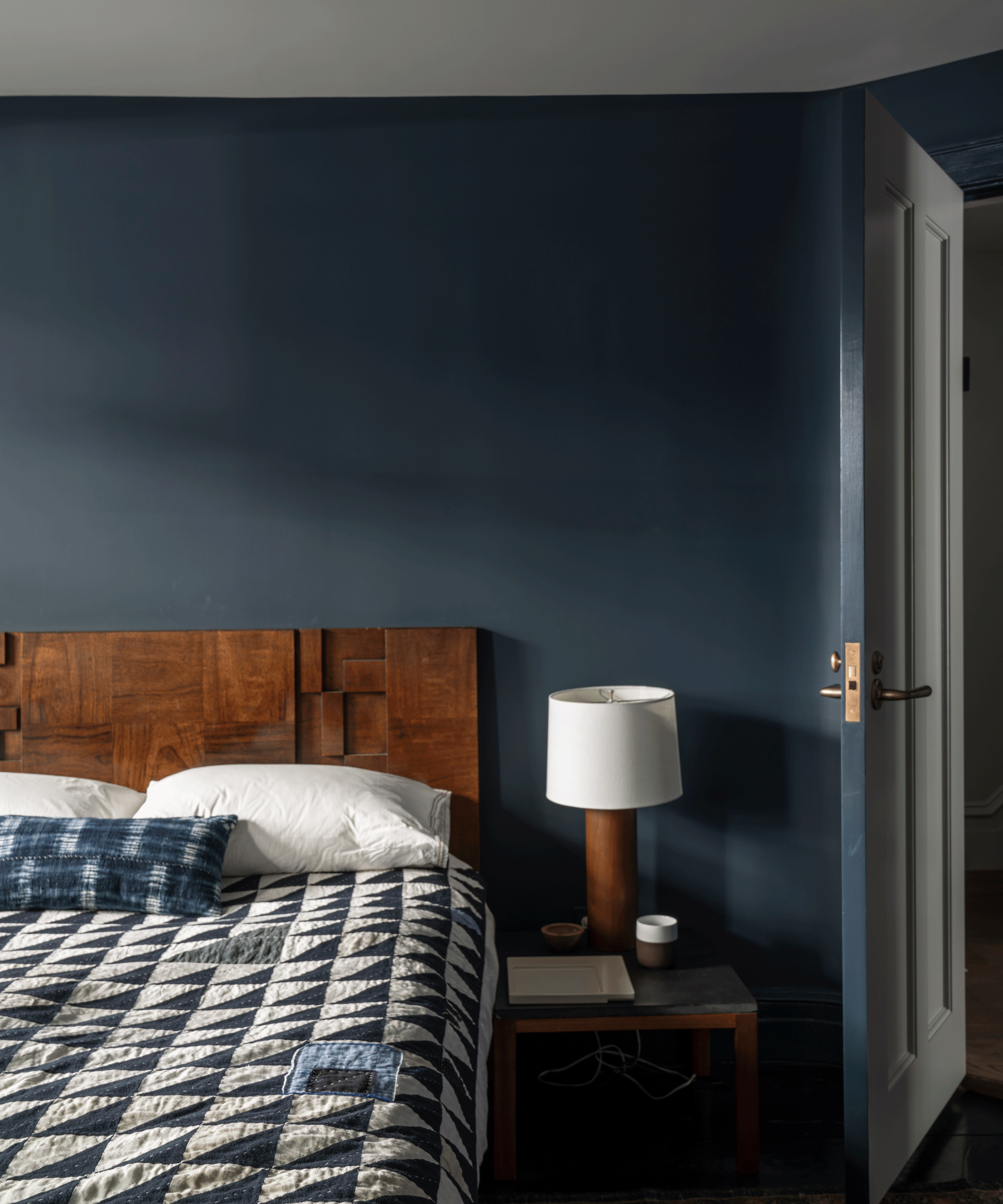 Navy blue bedroom with wood furniture
