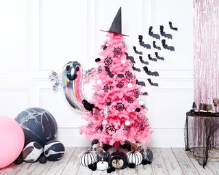 Pink Halloween Christmas tree with witches hat topper, black bat decor, monochrome pumpkins and ghost silver foil balloon