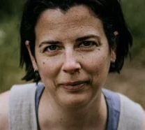 Headshot of a women with short dark hair and a grey top