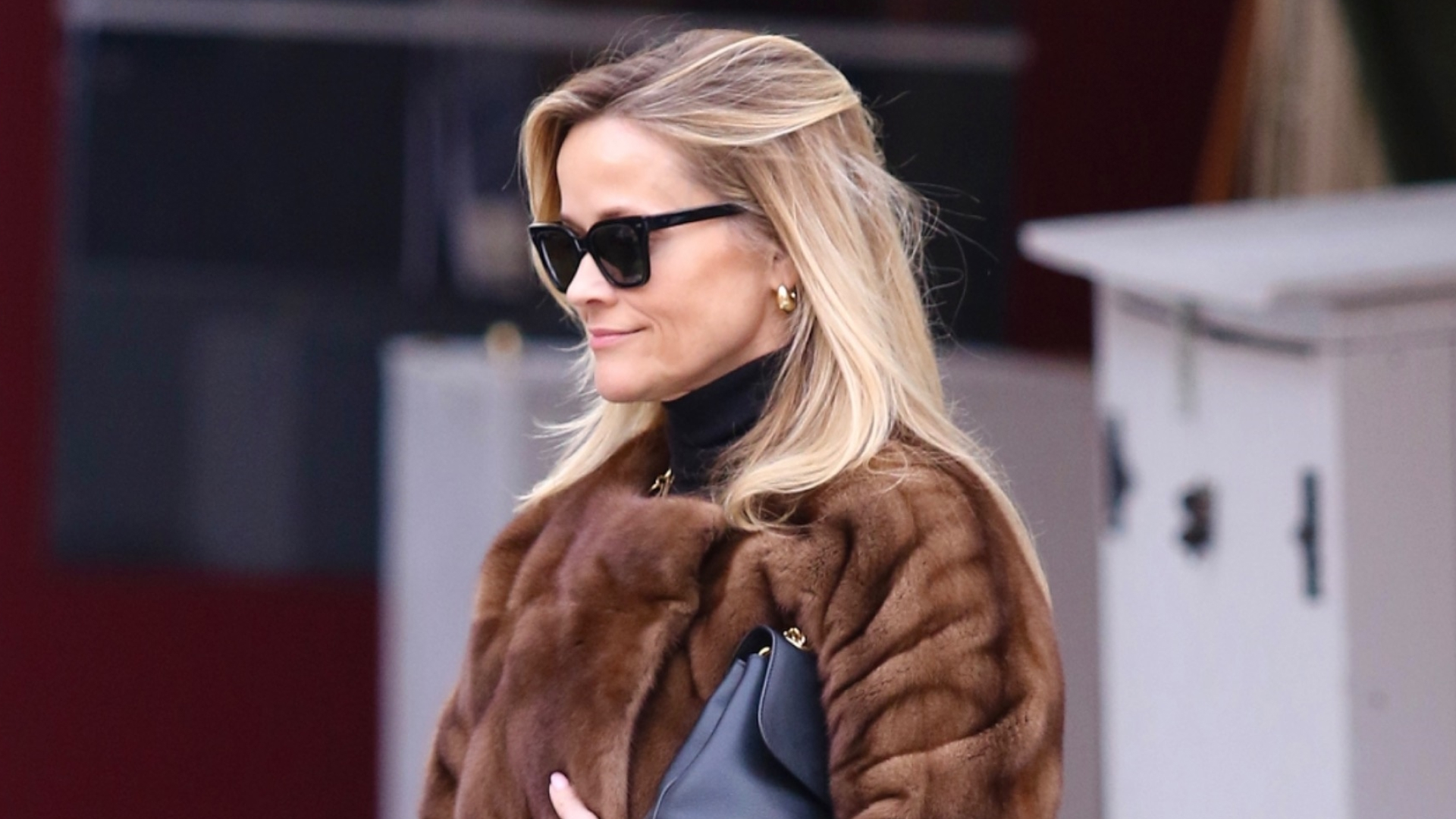 Reese Witherspoon Styles a Luxe Fur Coat With Chunky Black Boots and a Classic Bag