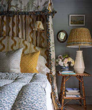 Bedroom with layered fabrics and a vintage fabric lampshade