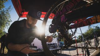 A race mechanic working on a downhill bike