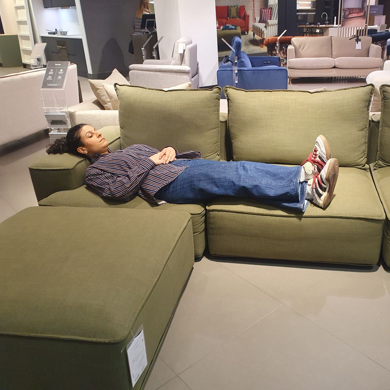 Sara lying down on the John Lewis Border sofa