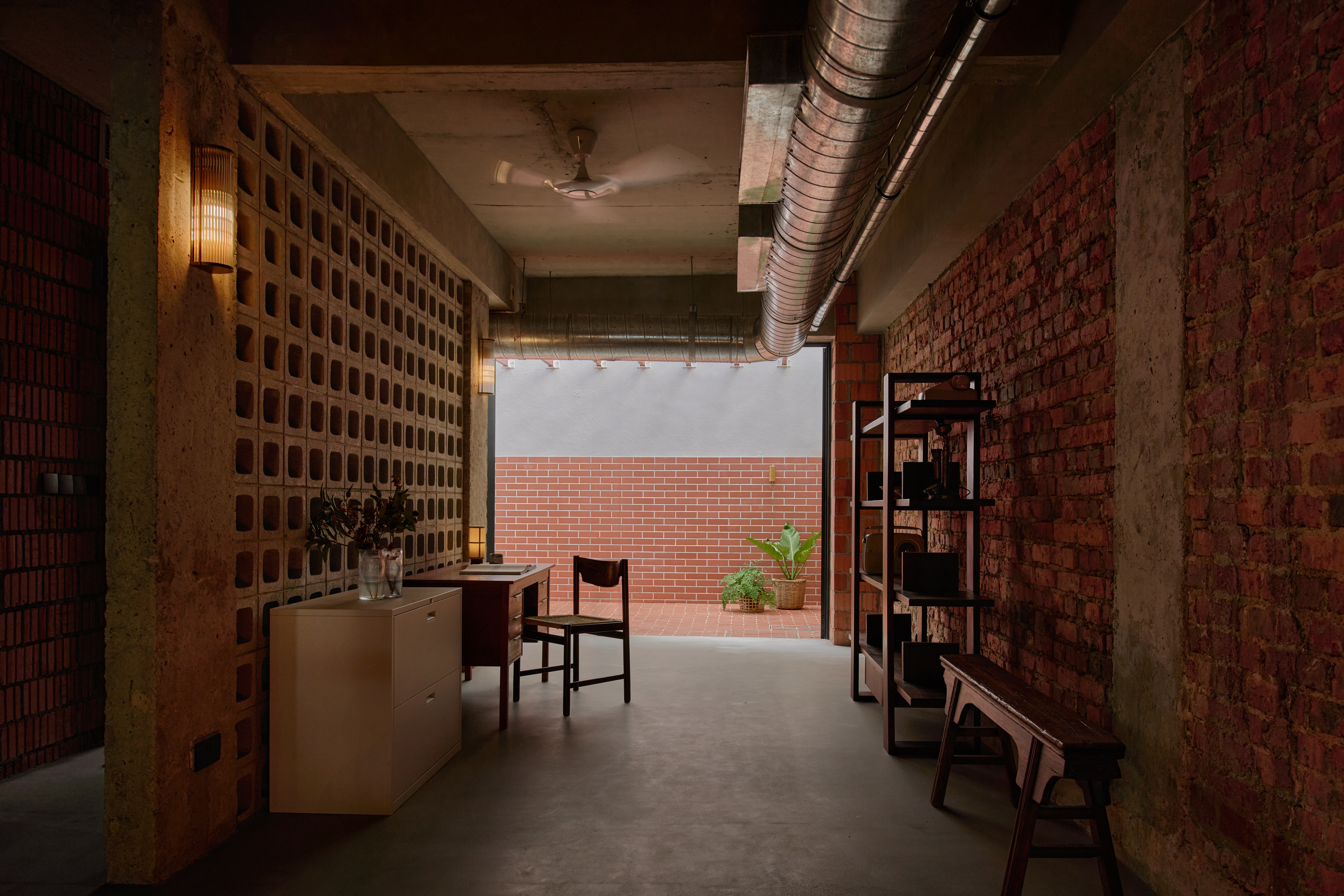 'My last home' by L Architects, a raw interior space of exposed brown brick and wood detailing