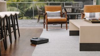 The Neato Intelligent D10 clearing carpet in a lounge