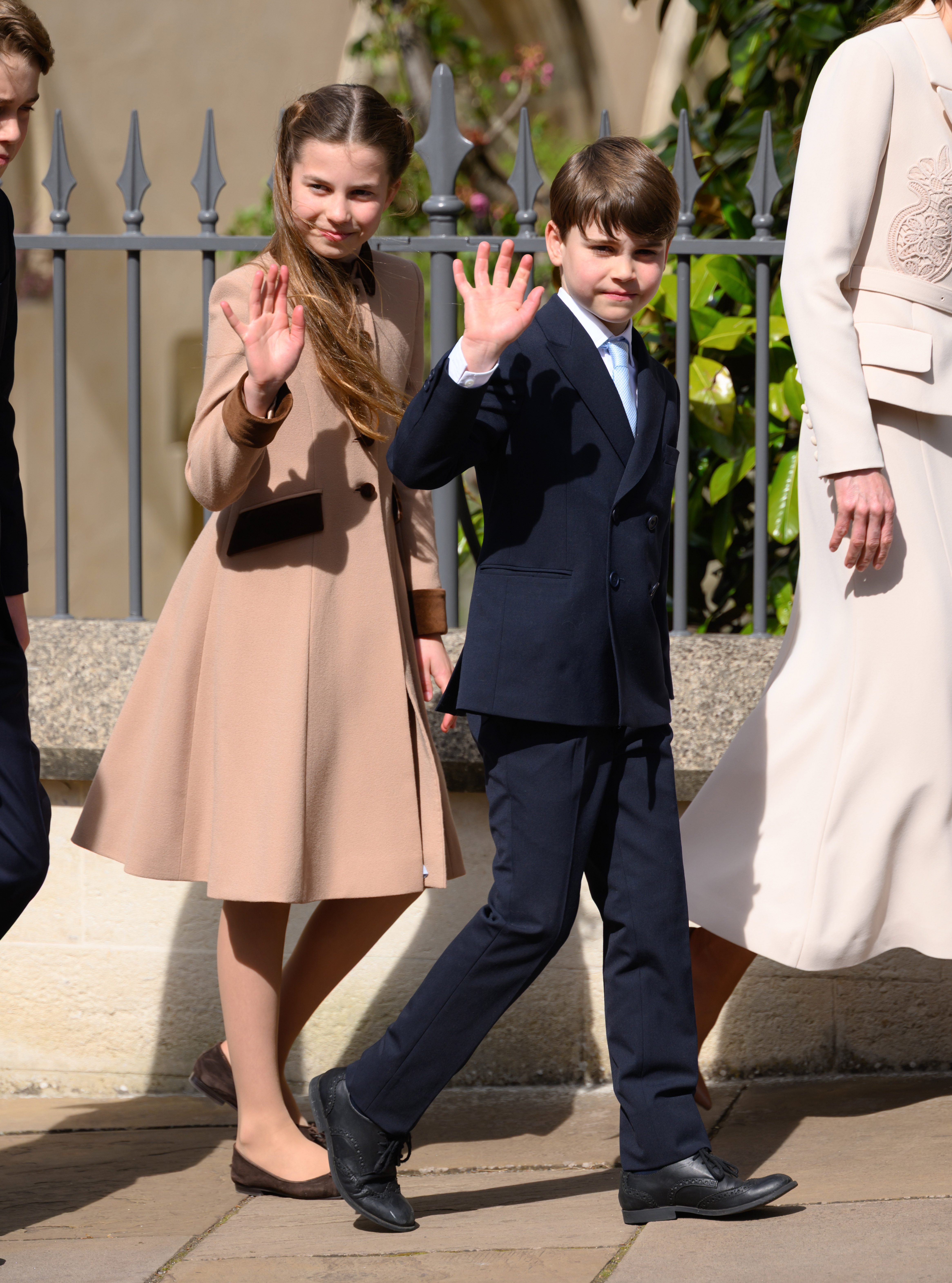 Princess Charlotte and Prince Louis wave at royal fans after the Royal Family's 2026 Easter Matins Service at St George's Chapel on April 05, 2026