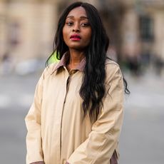 Carrole Sagba with hair in centre parting and trench coat GettyImages-1392571883