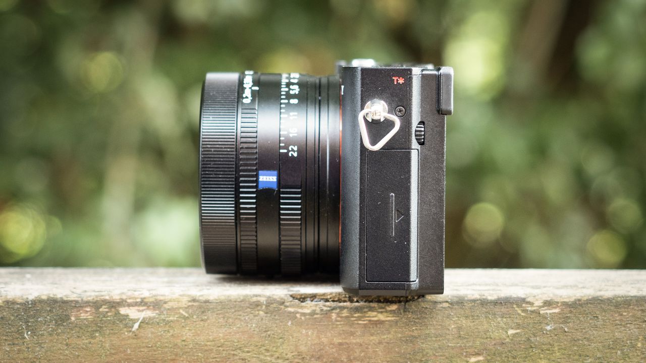 Sony RX1R III on a wooden surface in a woodland environment